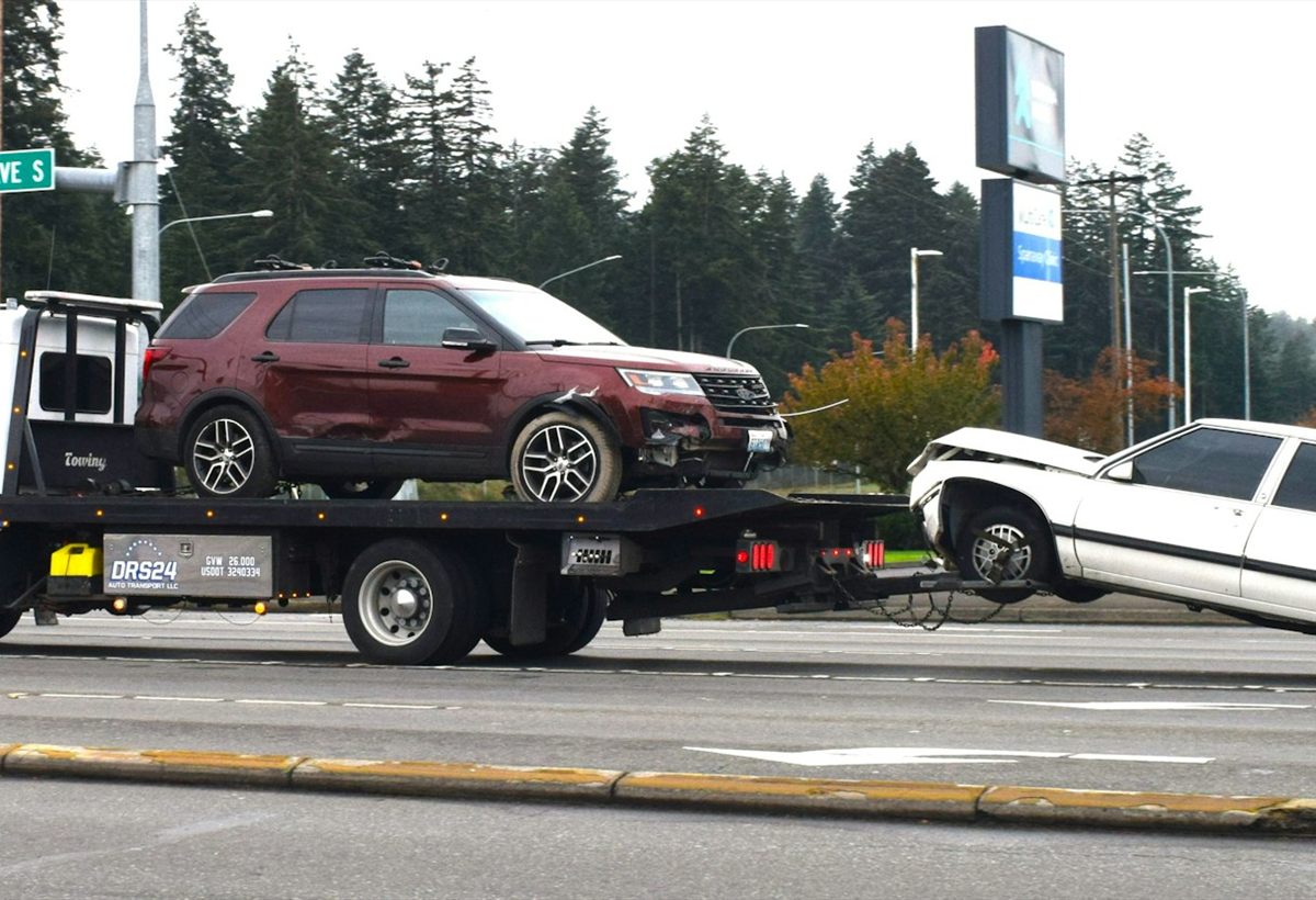 A recovery vehicle transporting a car after an incident
